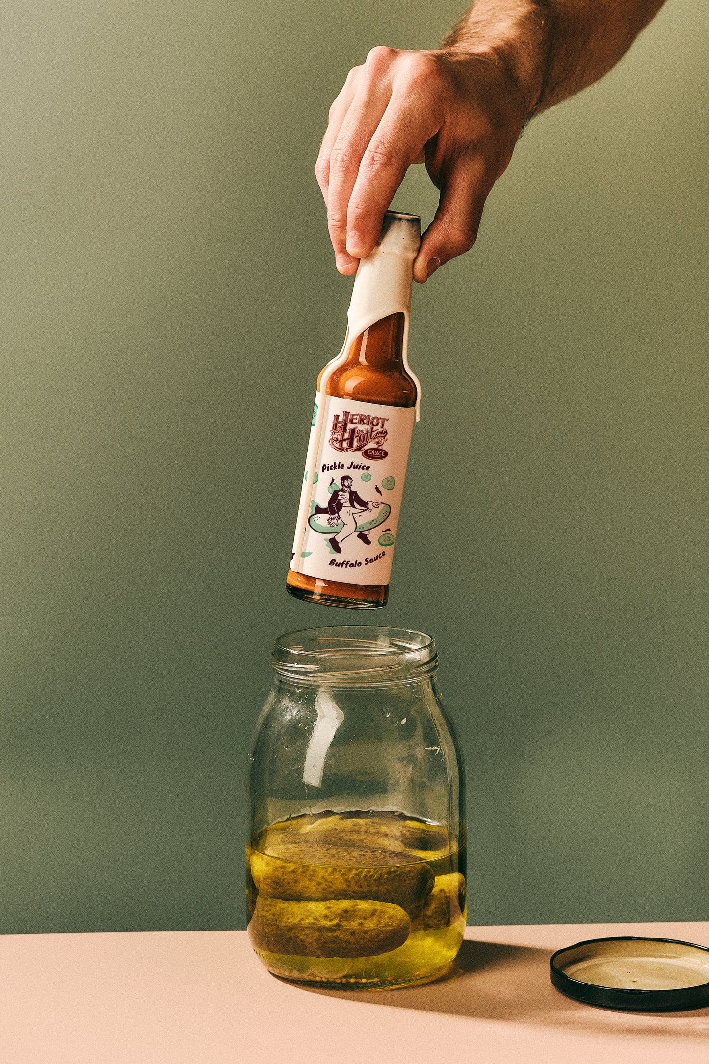 Lifting Pickle Juice Buffalo Hott Sauce out of Jar of Pickles - Heriot Hott